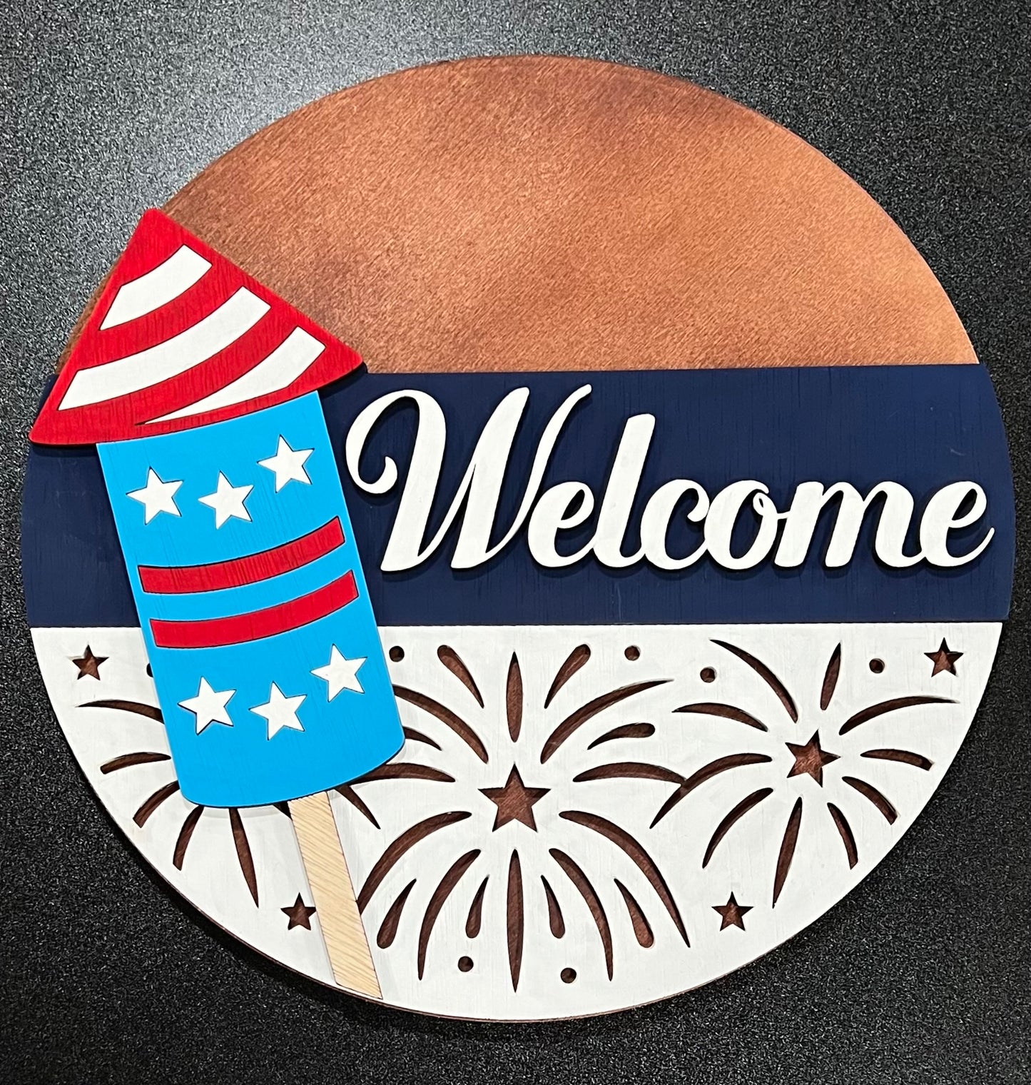 Welcome Firework U-Paint sign with a red, white, and blue firework.