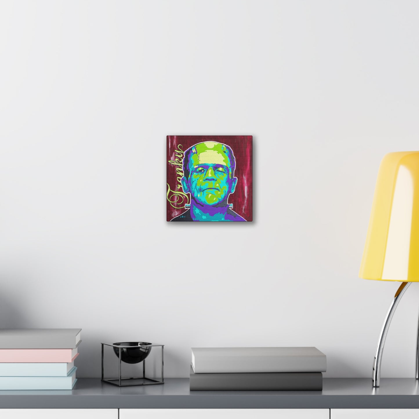 A canvas print of Frankenstein's monster in bright green and purple tones.