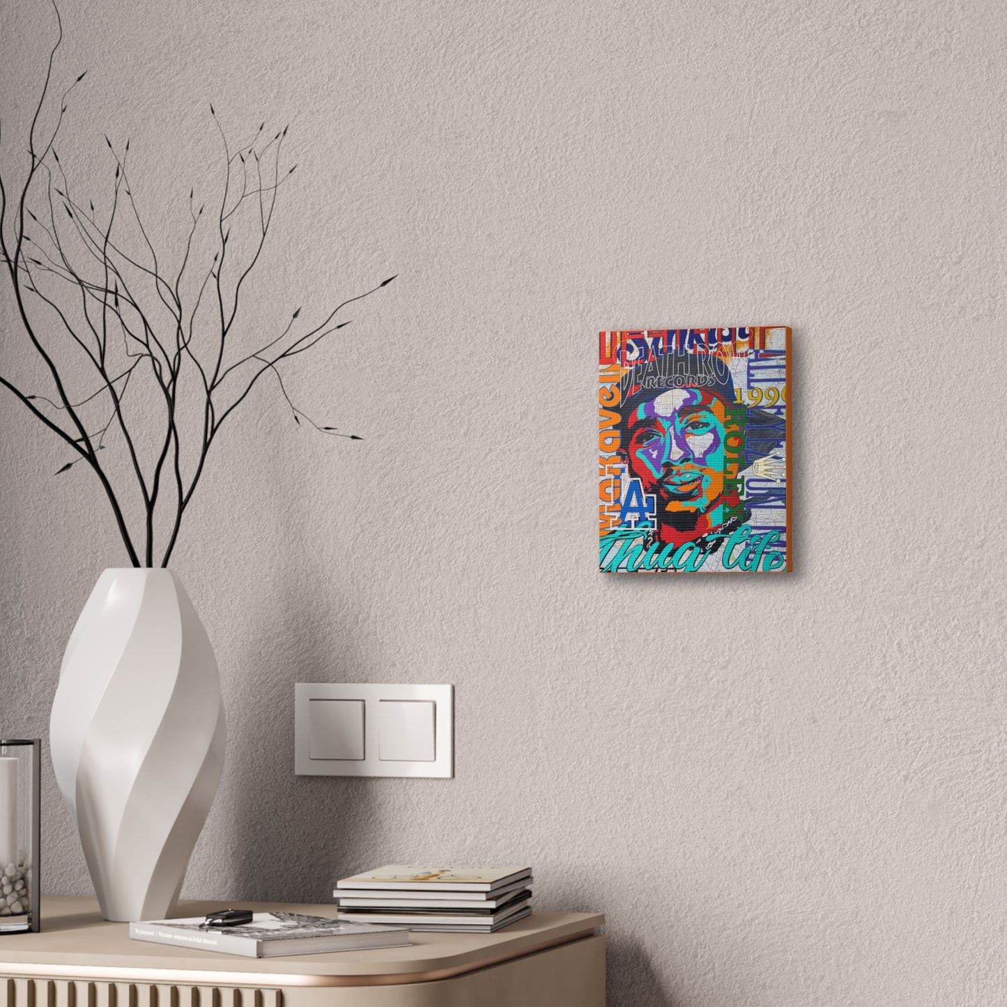 A colorful canvas gallery wrap featuring a stylized portrait of a man hangs on a textured wall.