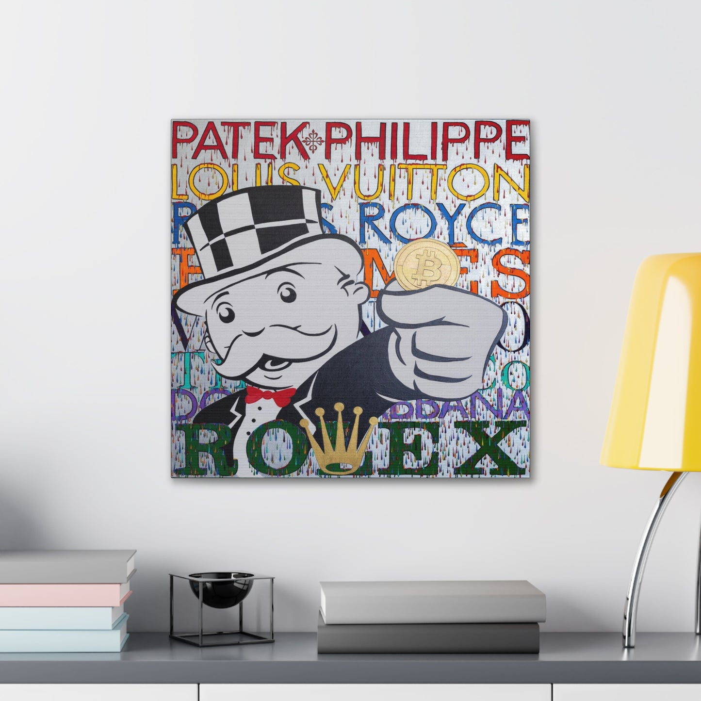 A canvas gallery wrap features a Monopoly man holding a Bitcoin, surrounded by luxury brand names.