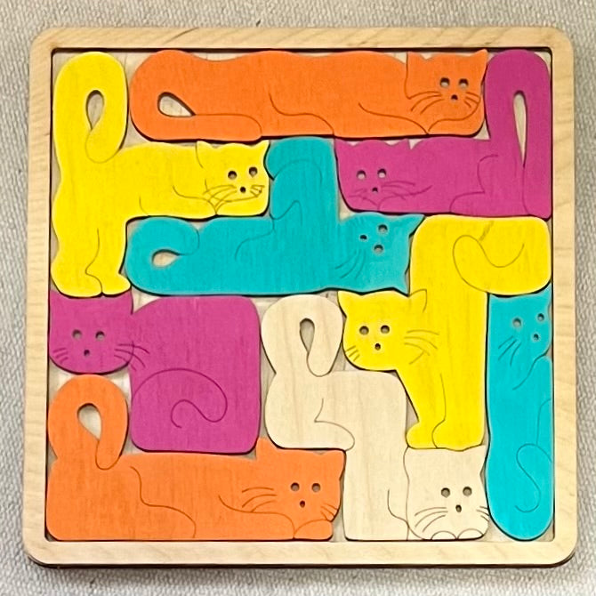 A square wooden puzzle with 14 colorful cat-shaped pieces.