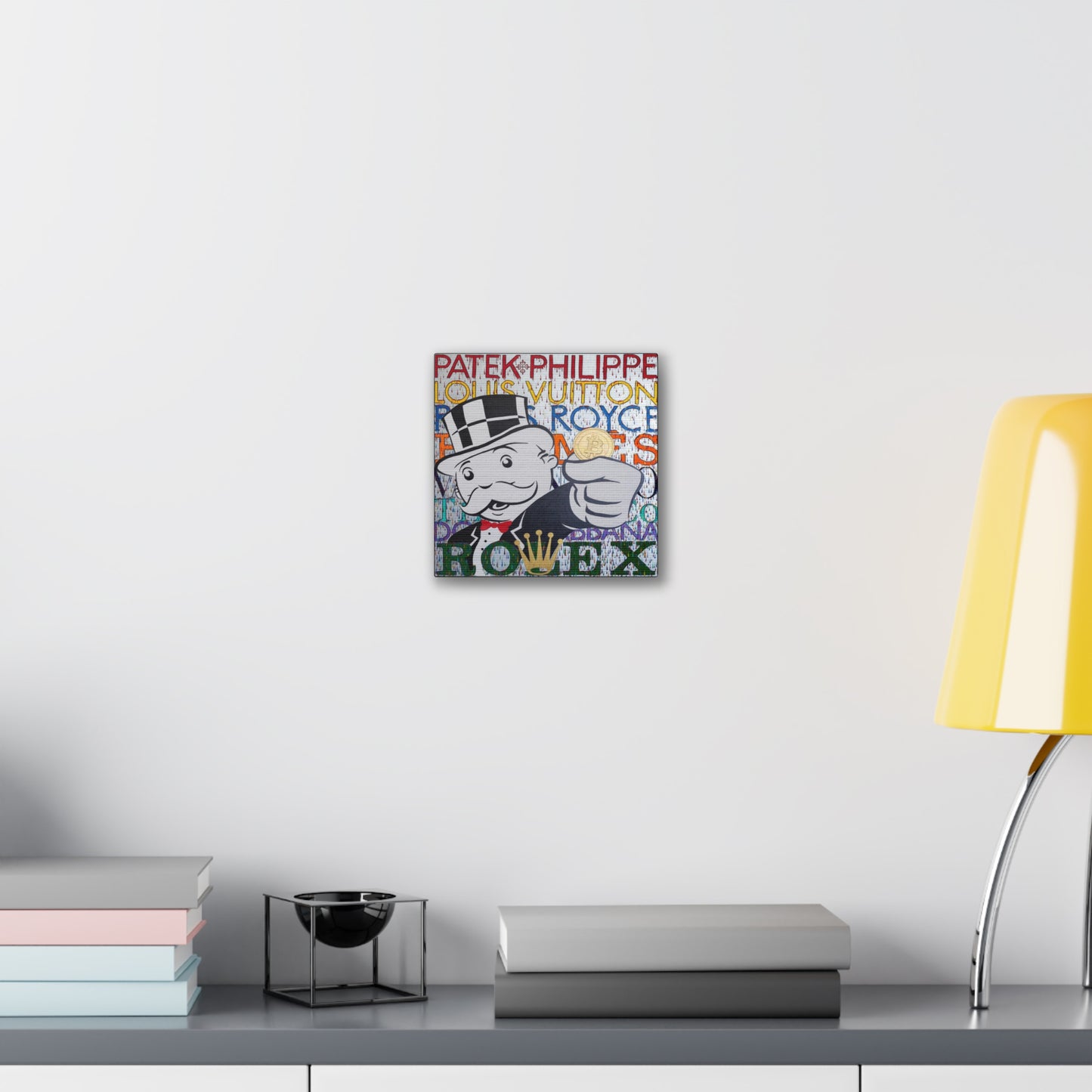 A canvas gallery wrap features a Monopoly man holding a Bitcoin, surrounded by luxury brand names.