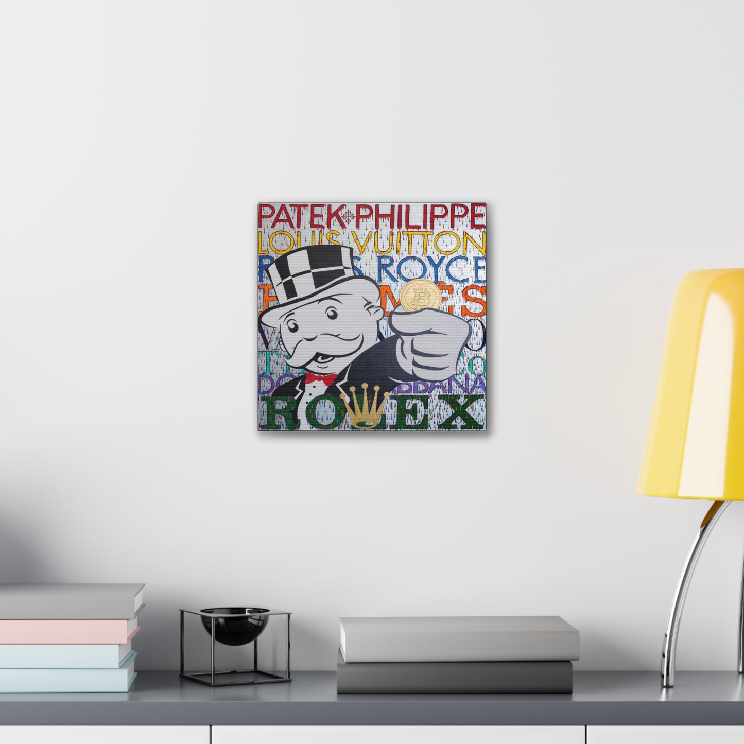 A canvas gallery wrap features a Monopoly man holding a Bitcoin, surrounded by luxury brand names.