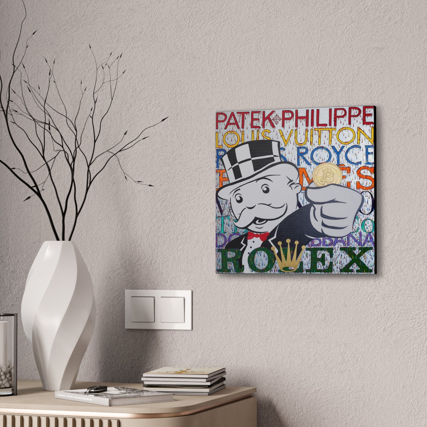 A canvas gallery wrap features a Monopoly man holding a Bitcoin, surrounded by luxury brand names.