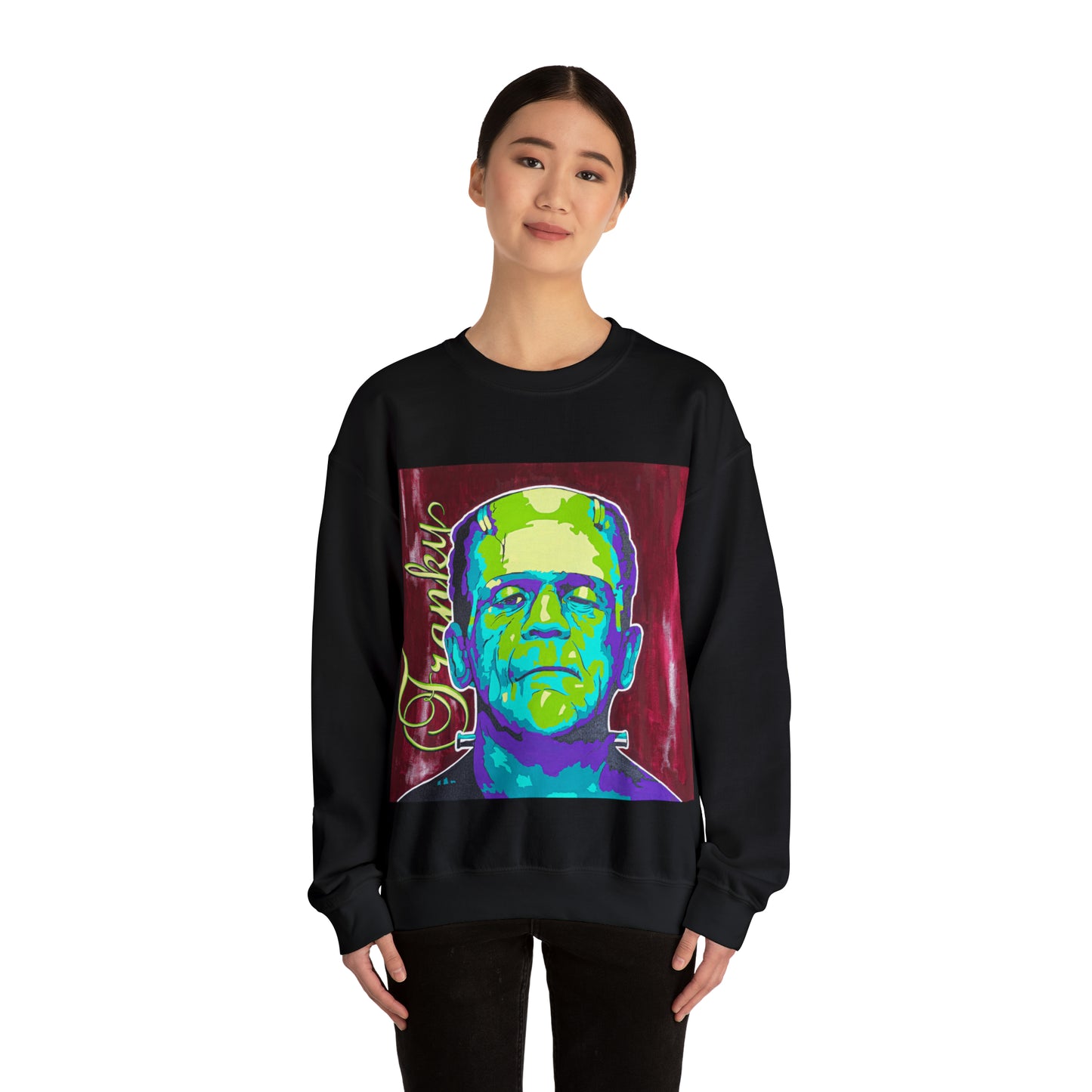 A woman models a black crew neck sweatshirt featuring a colorful graphic of Frankenstein's monster.