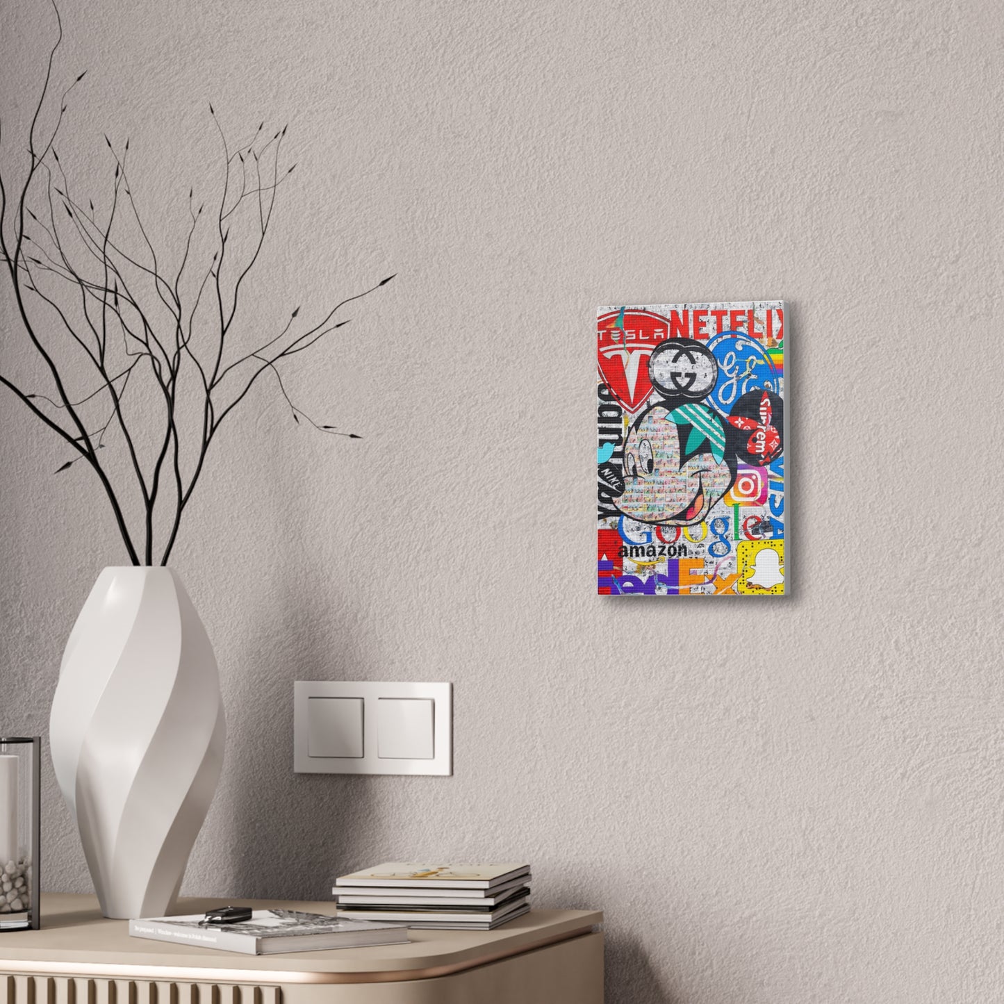 A canvas gallery wrap featuring a Mickey Mouse logo surrounded by brand names.
