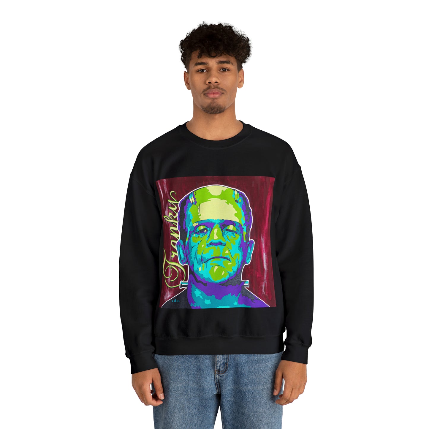 A man wears a black crew neck sweatshirt with a colorful graphic of Frankenstein's monster.