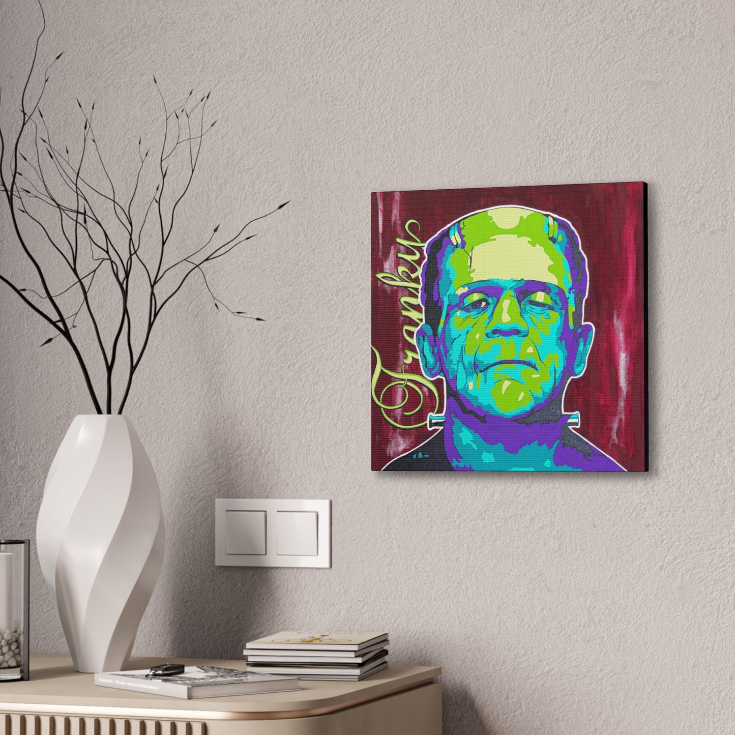 A colorful pop art style canvas print of Frankenstein's monster hangs on a wall.