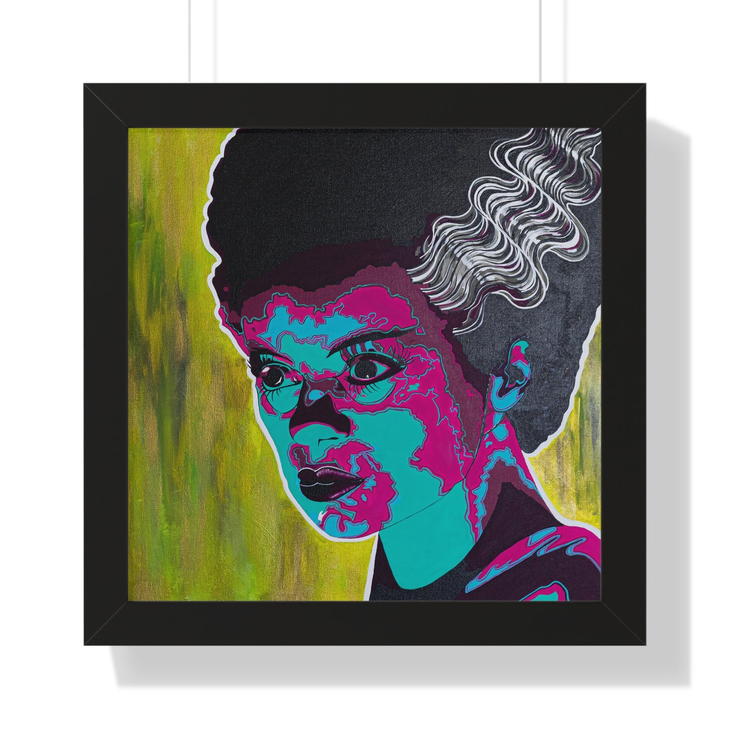 A framed poster features a pop art style portrait of a woman with dark hair and colorful skin.