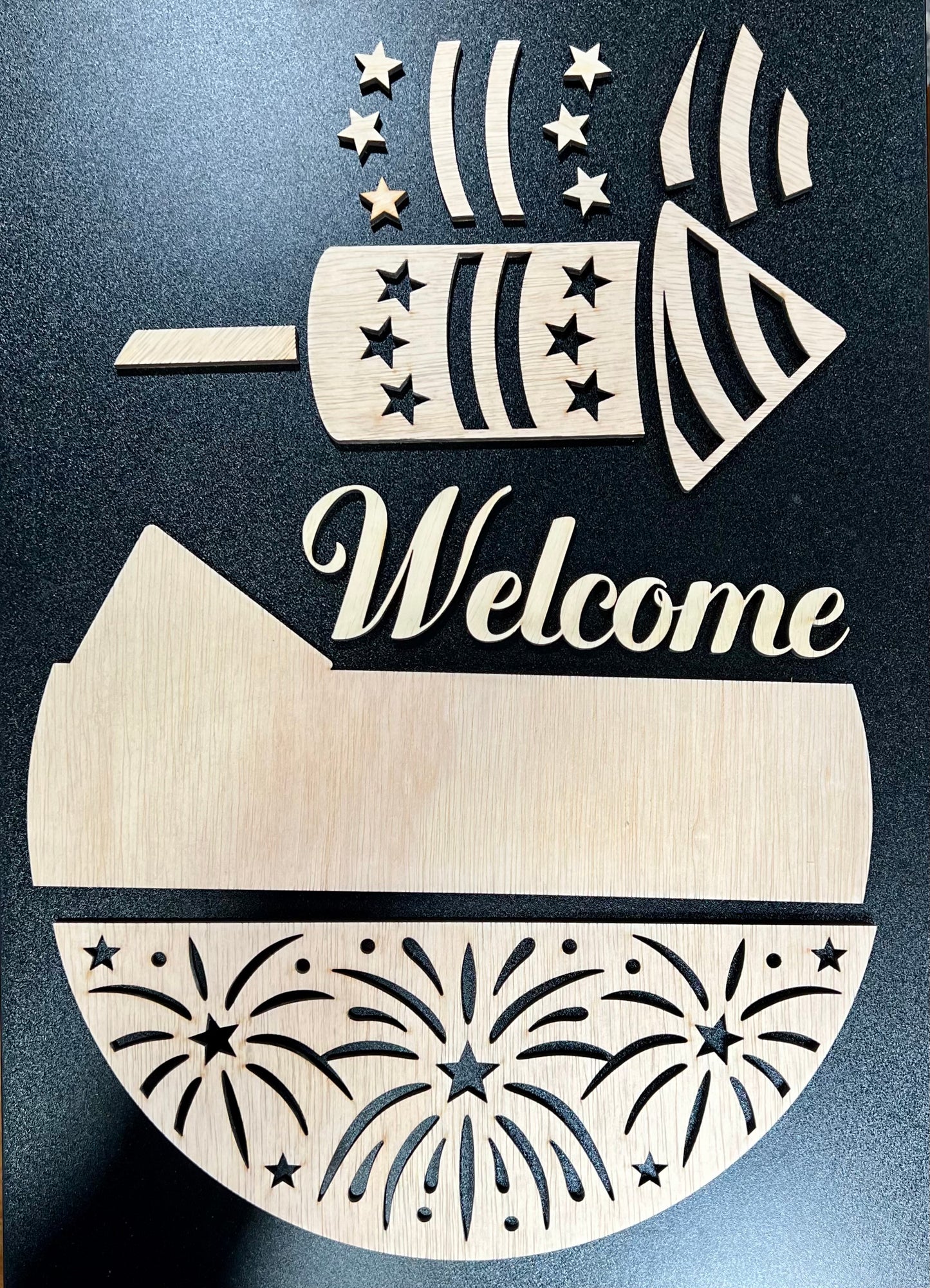 Unfinished wooden sign pieces for a "Welcome Firework" design.