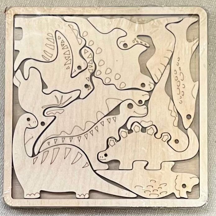 Unfinished wood square puzzle with multiple dinosaur-shaped pieces.