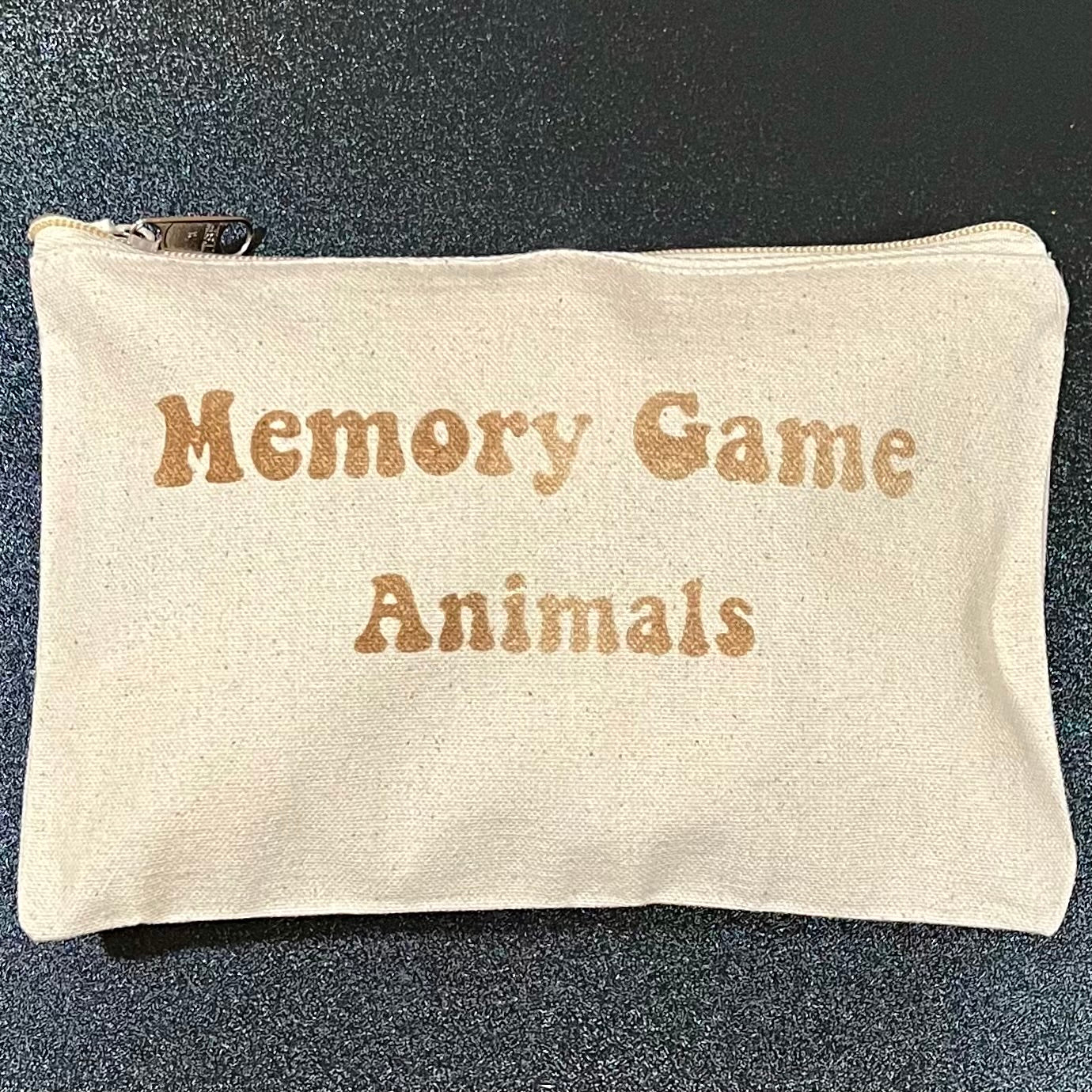 Linen zipper bag with "Memory Game Animals" printed in brown text.