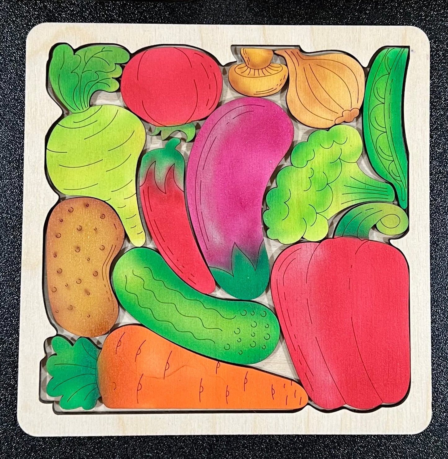 A wooden puzzle with colorful vegetable pieces.