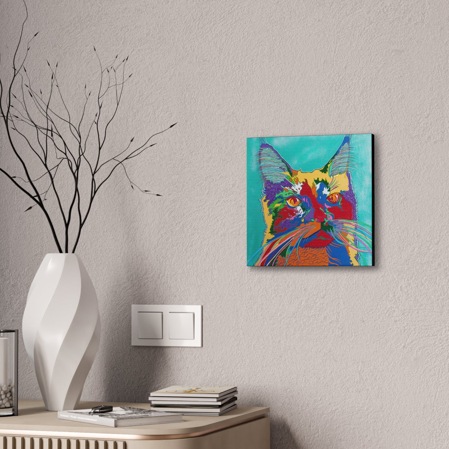 A vibrant pop art style cat portrait on a canvas gallery wrap hangs on a textured wall.