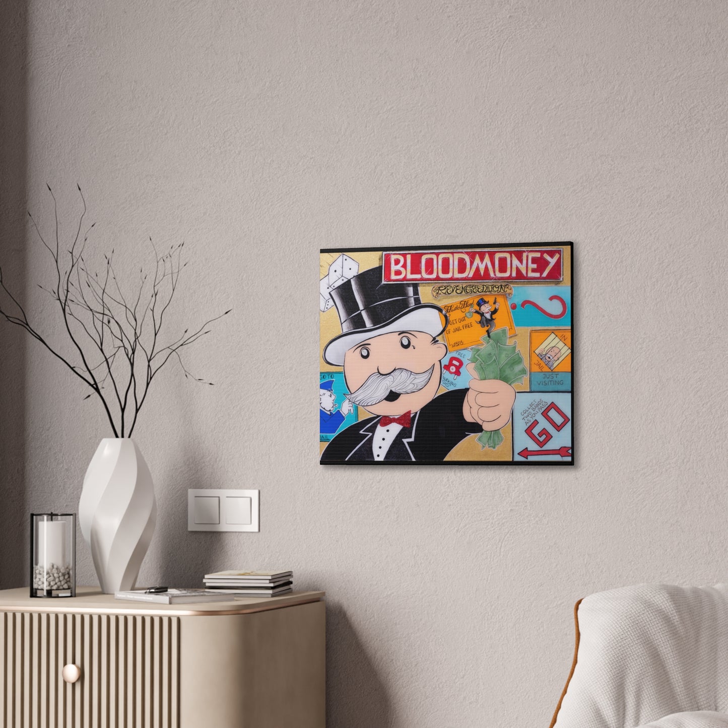 A framed canvas print featuring a Monopoly-inspired "Bloodmoney" design hangs on a wall.