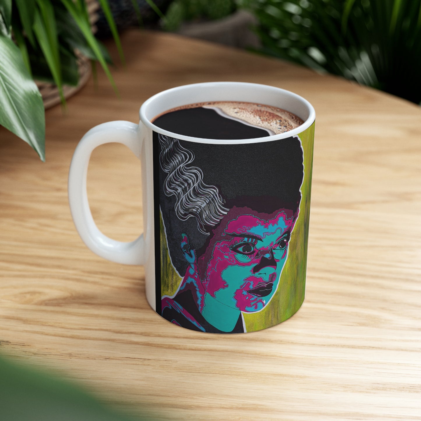 White ceramic mug with a colorful graphic of the Bride of Frankenstein.