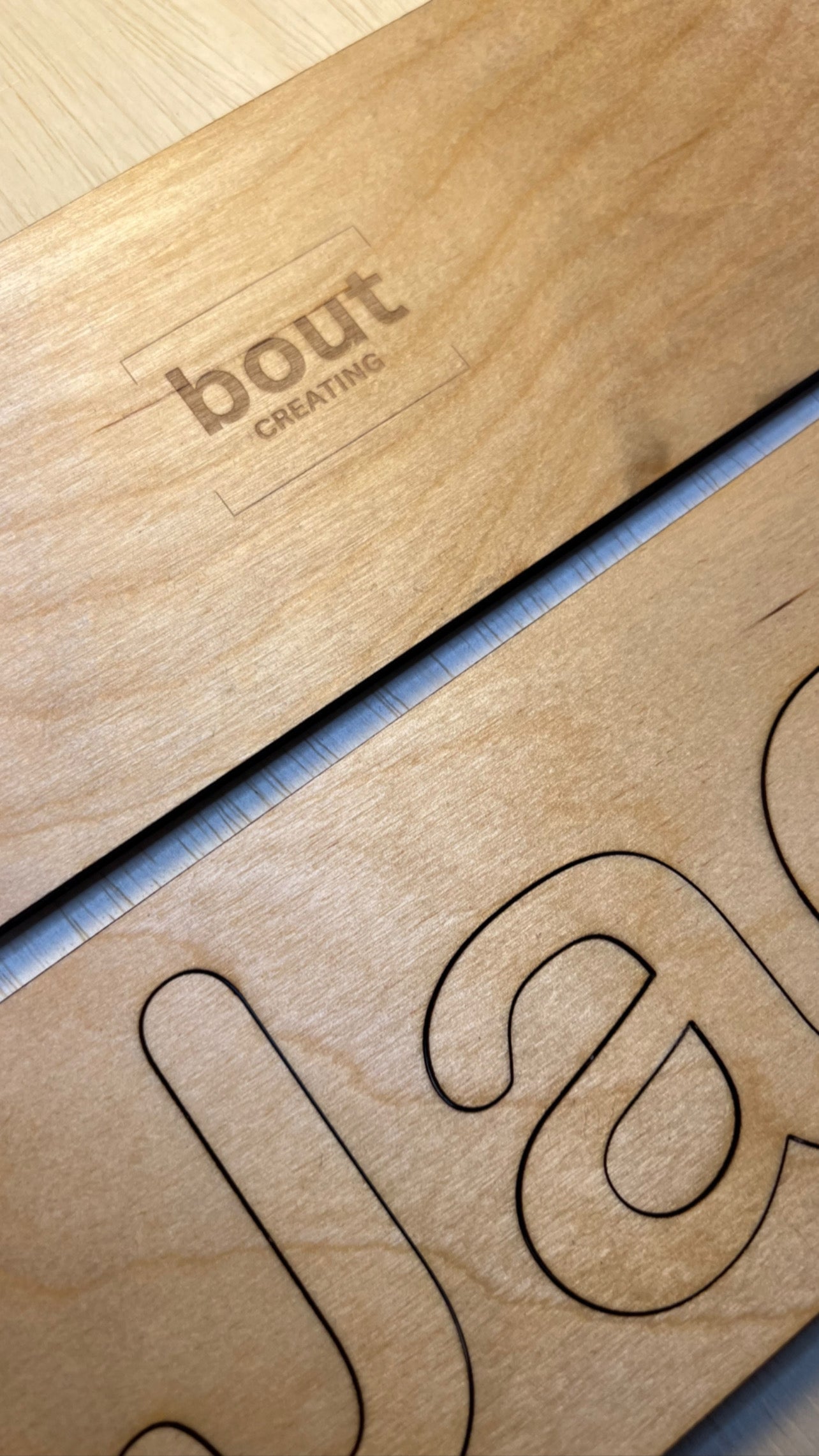 Custom wooden name puzzle with the word "bout" and "creating" engraved on it.