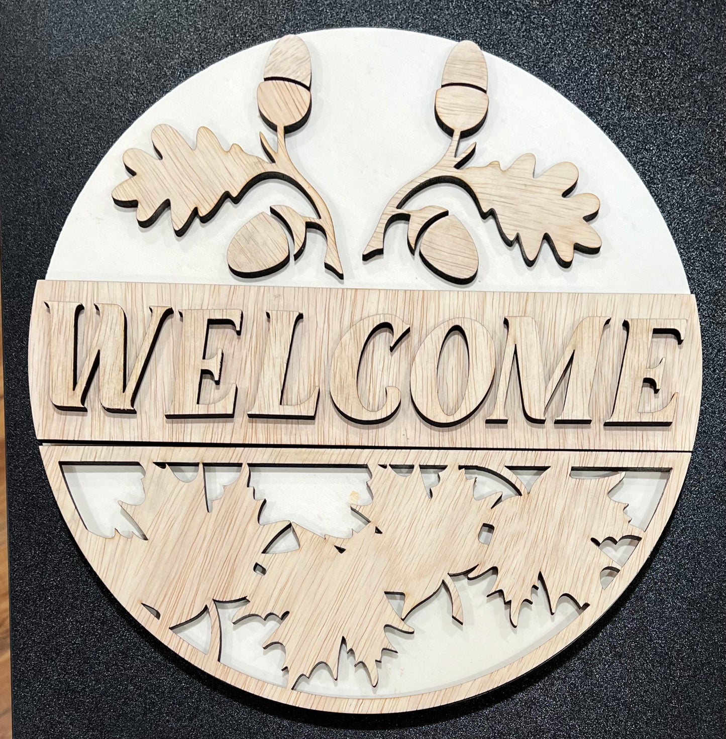Unpainted wooden oval sign with "WELCOME" and fall-themed cutouts.