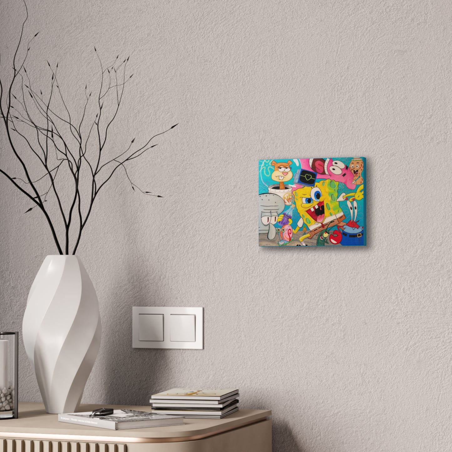 A colorful Spongebob Squarepants canvas gallery wrap hangs on a textured wall.
