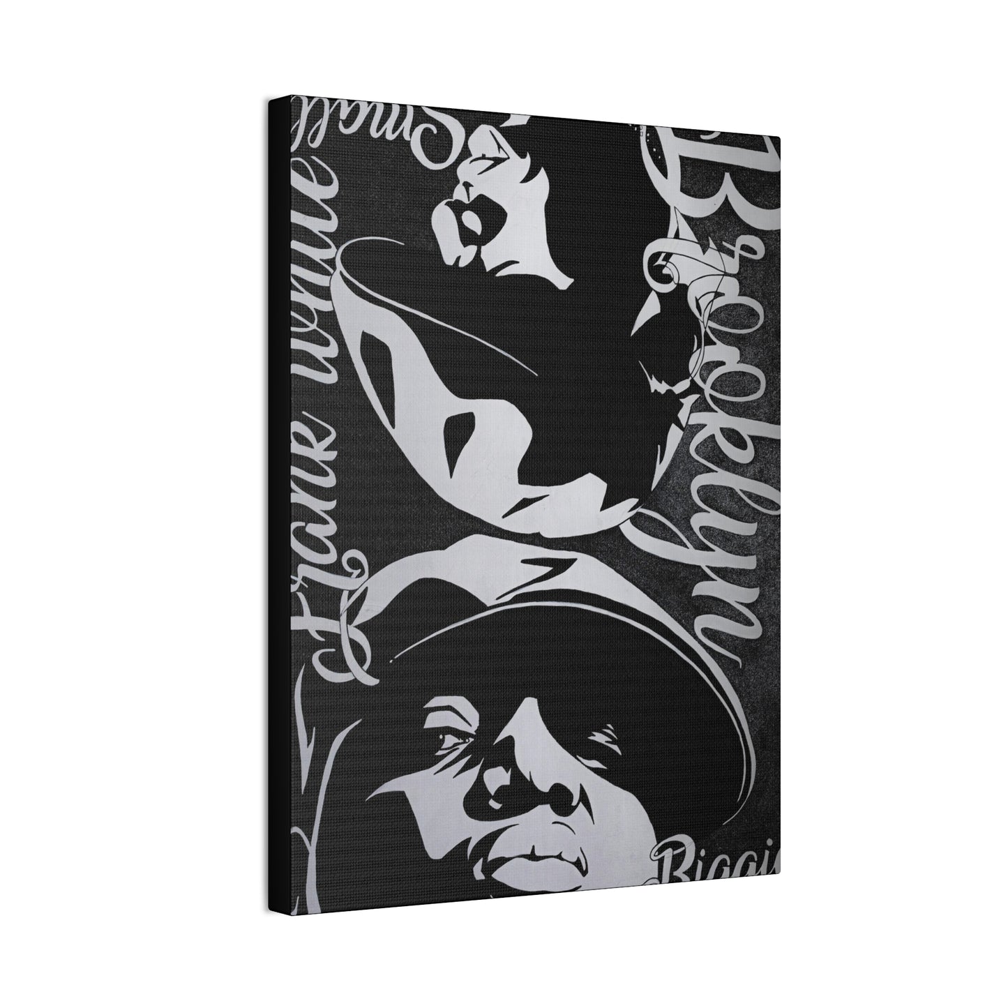 A black and white canvas print features portraits of Amy Winehouse and Notorious B.I.G.