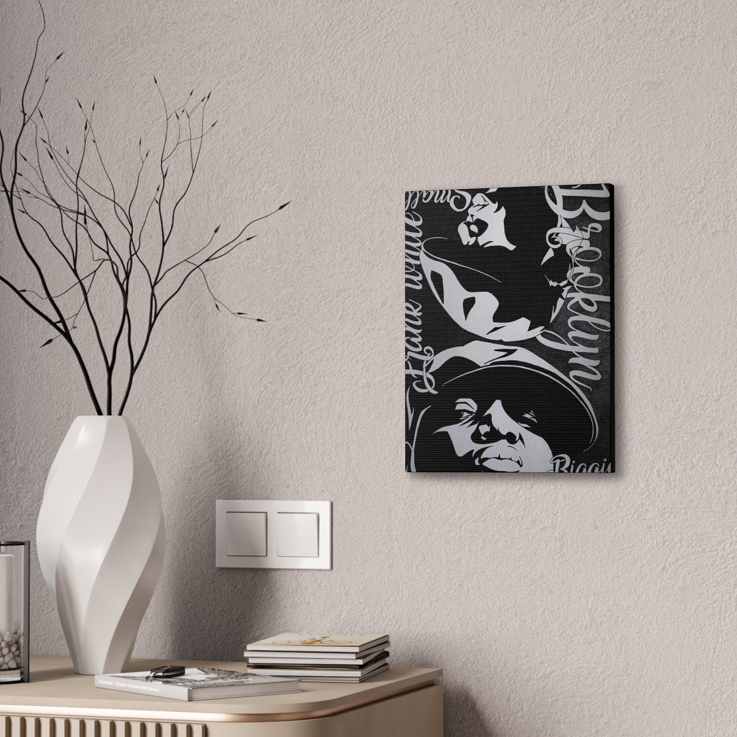 Black and white Biggie Smalls canvas art hangs on a textured wall.