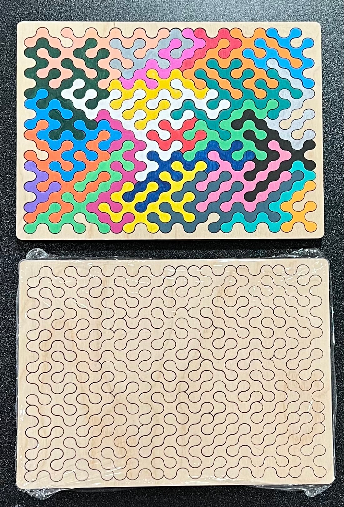 Two wooden puzzles, one assembled with colorful pieces, the other with outlines.