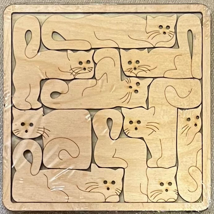 Unfinished wood square puzzle with multiple cat-shaped pieces.