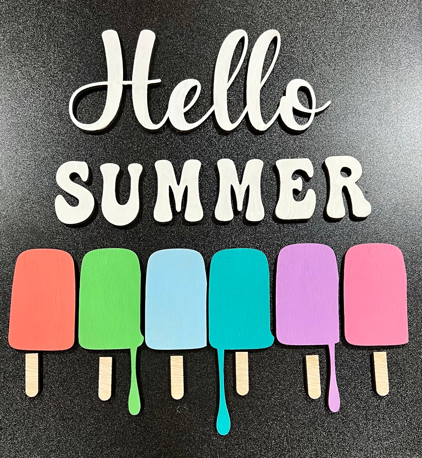 Hello Summer sign with colorful popsicle cutouts.
