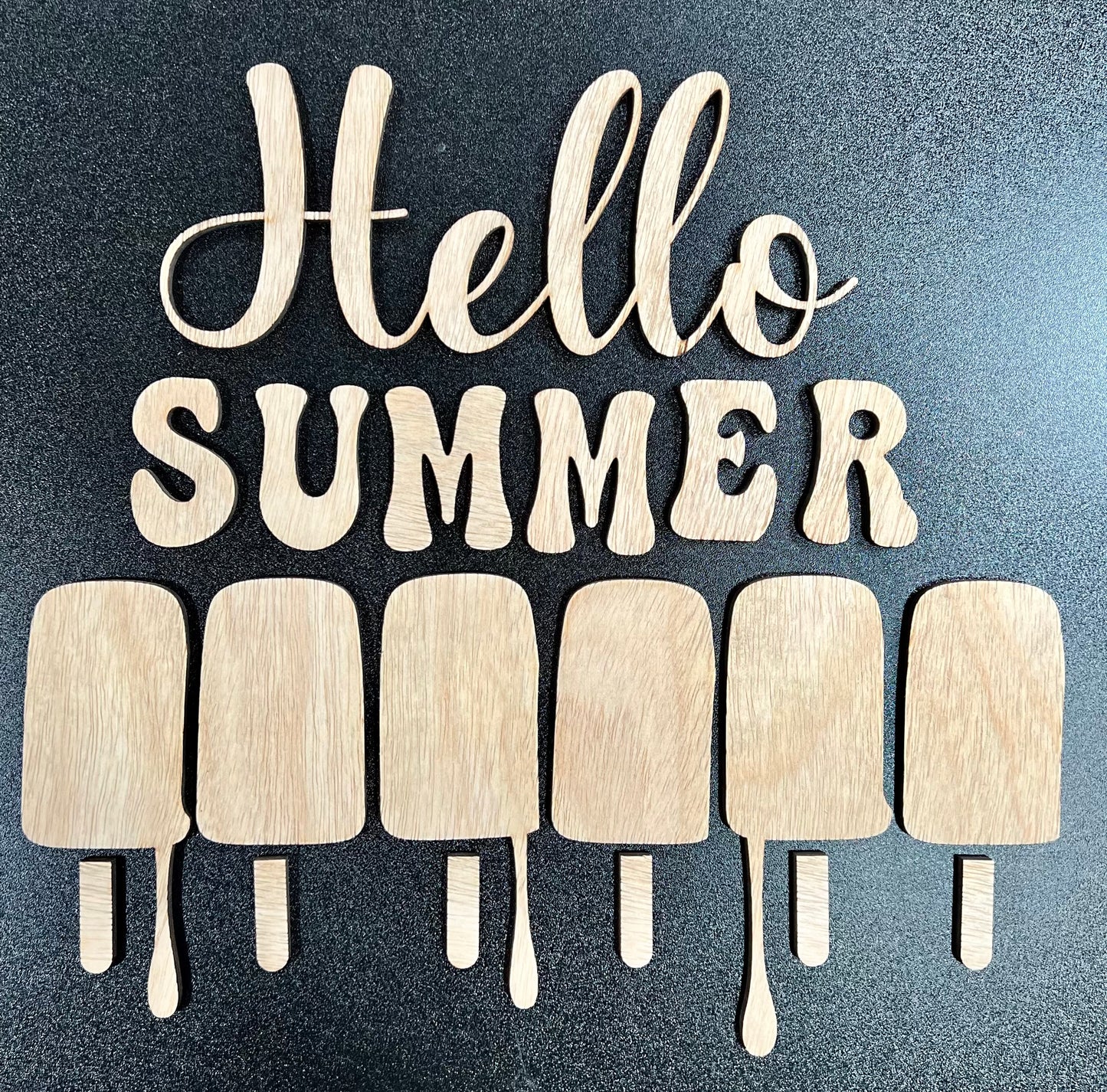 Unpainted wooden "Hello Summer" sign with six popsicle shapes.