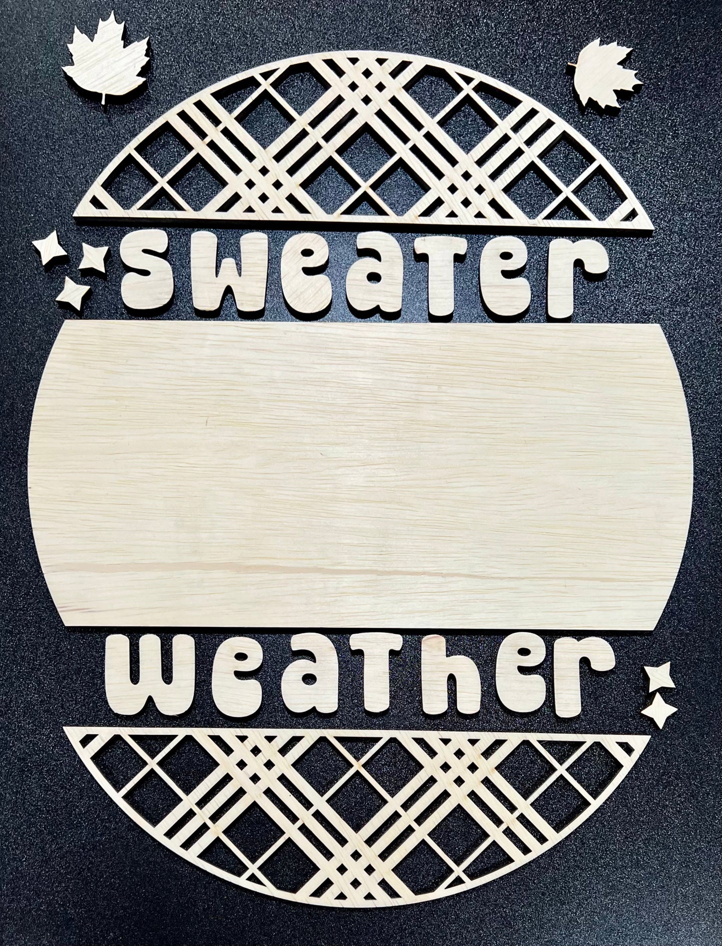 Unpainted wood craft kit spelling "sweater weather" with decorative elements.