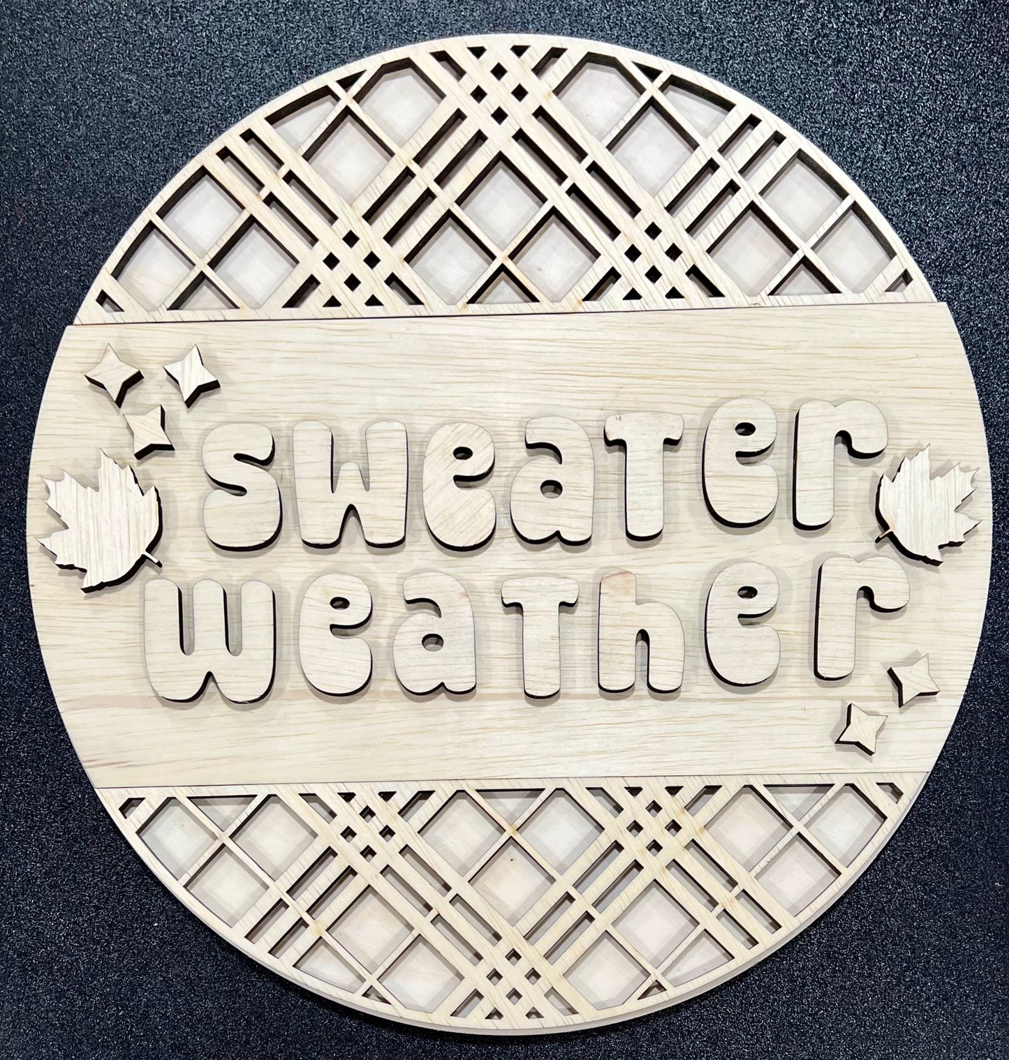 Unpainted wood craft kit with "Sweater Weather" text and fall leaf accents.