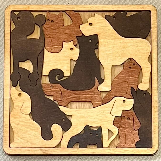 A square wooden puzzle features various dog-shaped pieces in different wood tones.