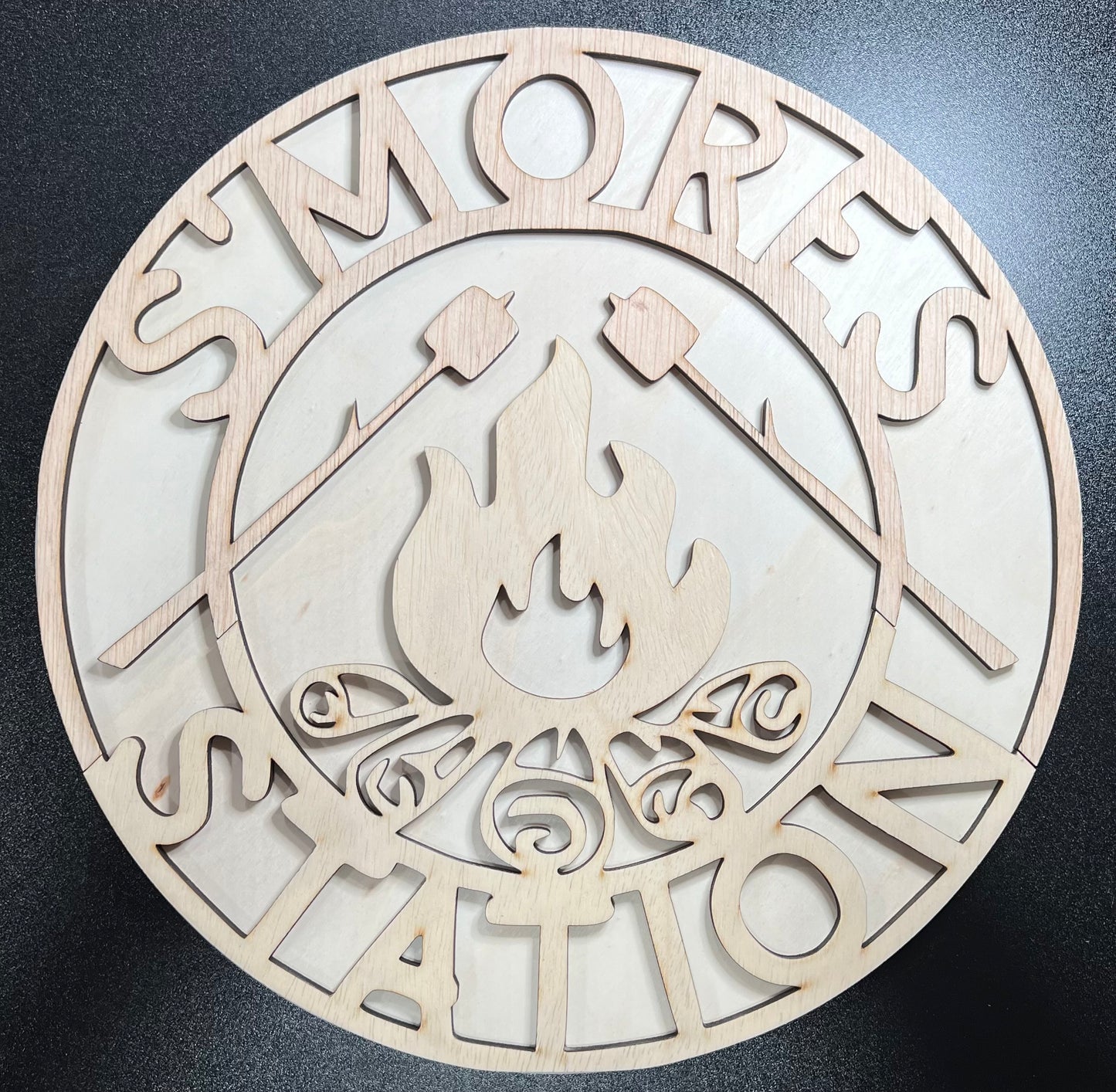 Unpainted wooden "S'mores Station" sign with marshmallow and campfire cutouts.
