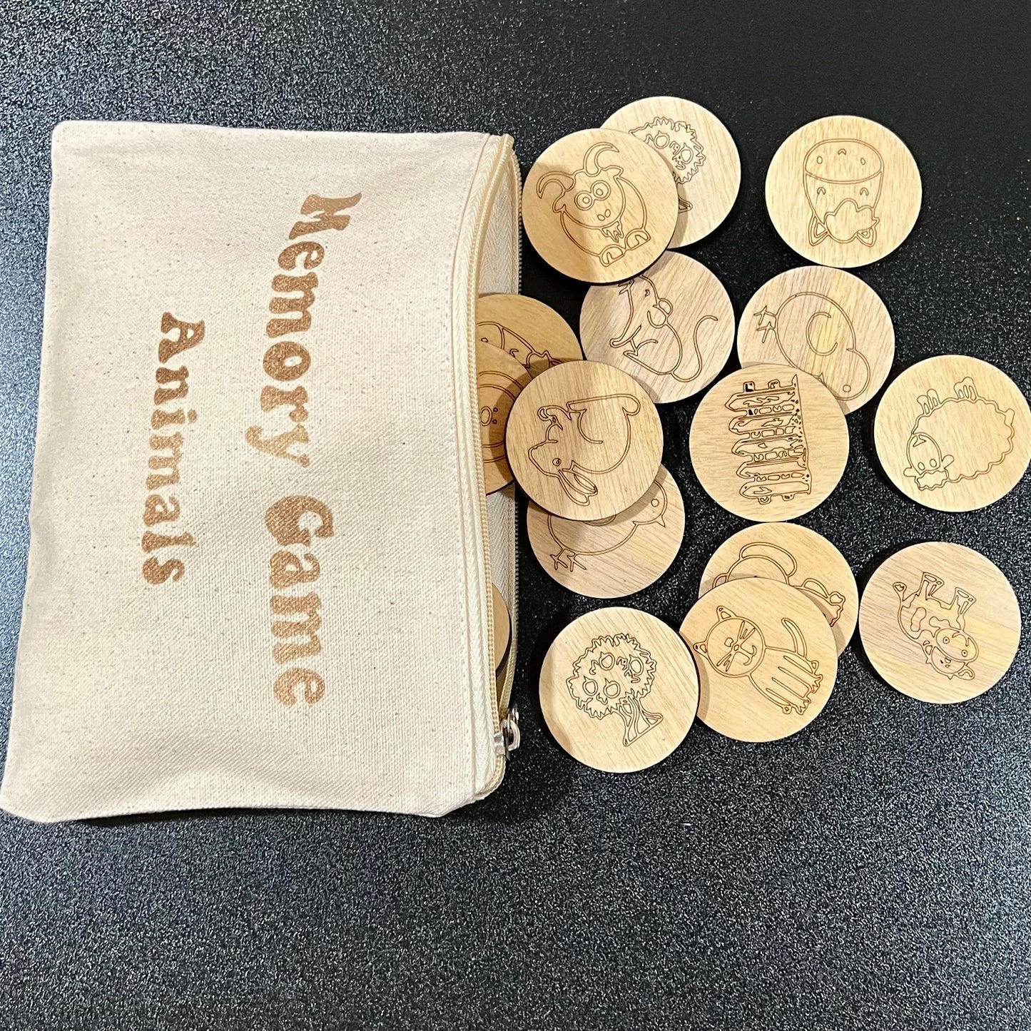Wooden memory game with farm animal designs and a linen zipper bag.