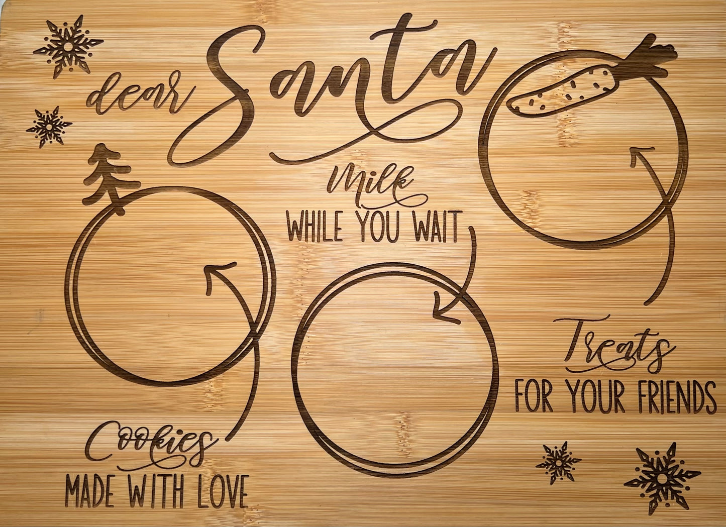 Engraved bamboo "Dear Santa" cookie and milk tray with snowflake and tree designs.