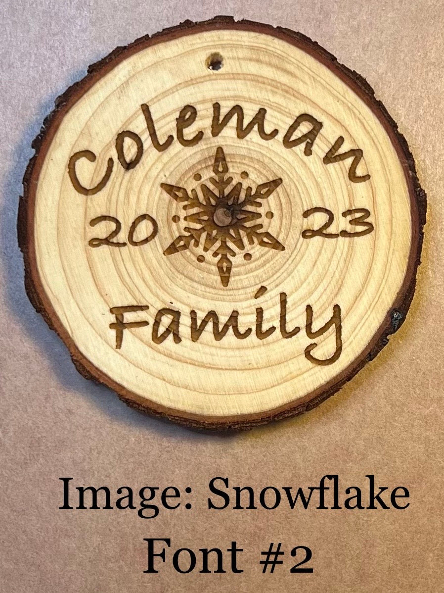 Personalized wood slice ornament with "Coleman 2023 Family" and a snowflake design.