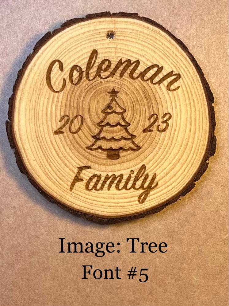 Personalized log wood round ornament engraved with "Coleman Family," a tree, and "2023."