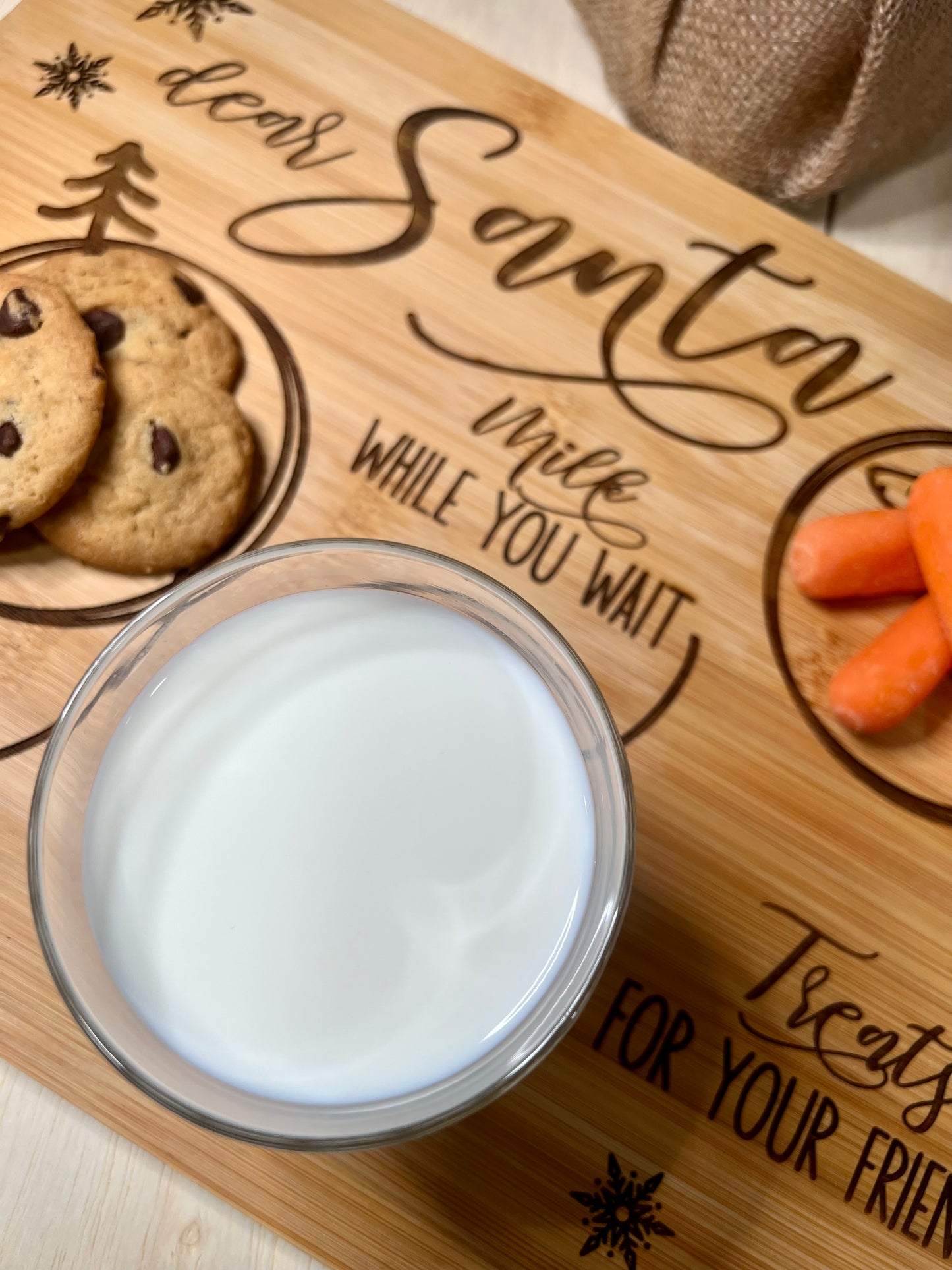 Engraved bamboo "Dear Santa" tray with cookies, milk, and carrots.