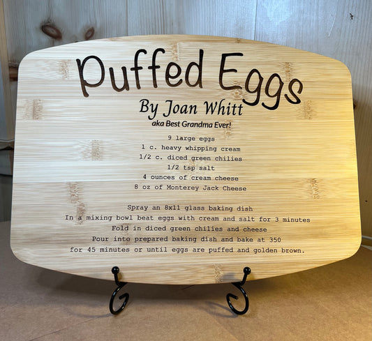 Recipe engraved bamboo board with a black display stand.