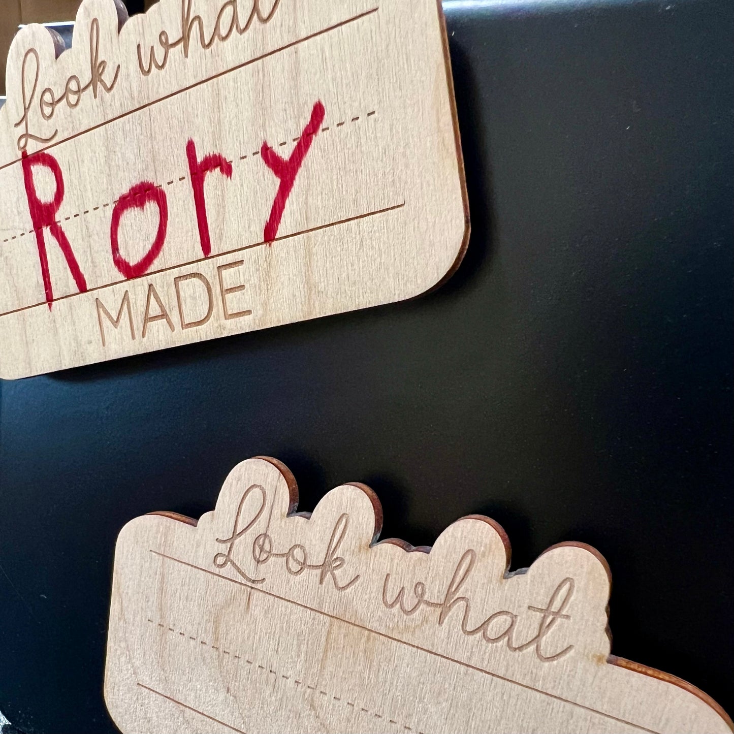 Two wooden "Look What _ Made" magnets, one with "Rory" written in red.