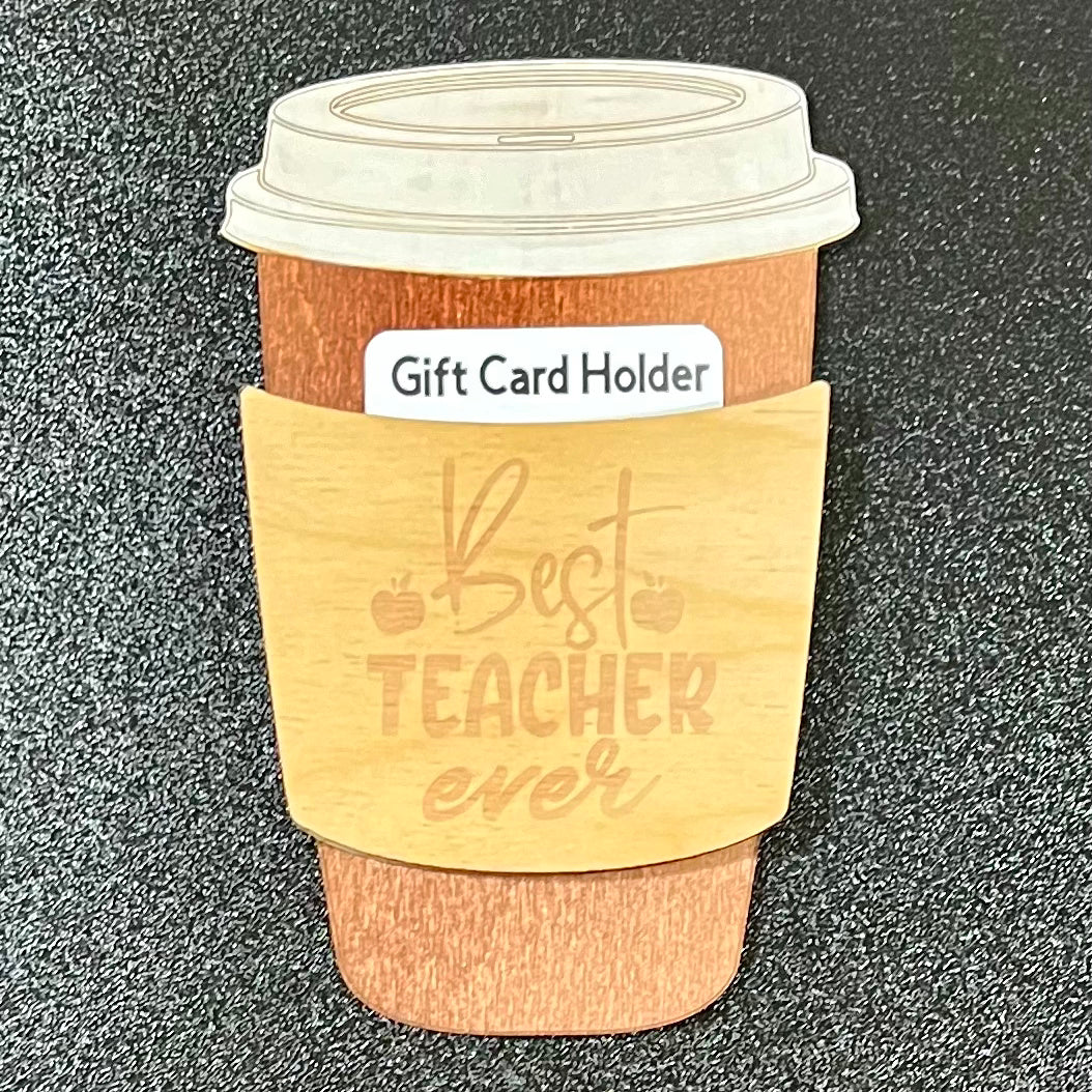 A wooden coffee cup-shaped gift card holder with "Best Teacher ever" engraved.