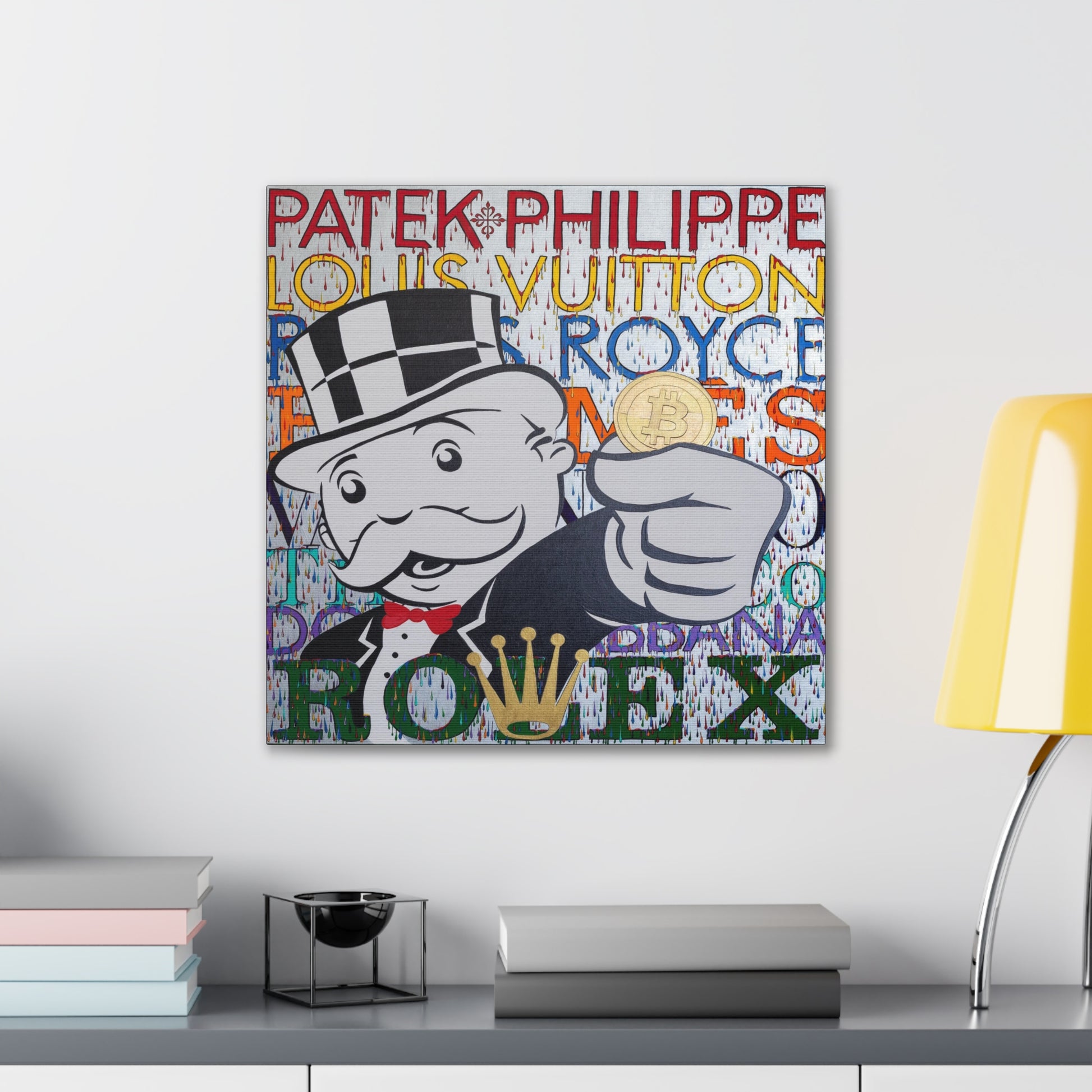 A canvas gallery wrap features a Monopoly man holding a Bitcoin, surrounded by luxury brand names.