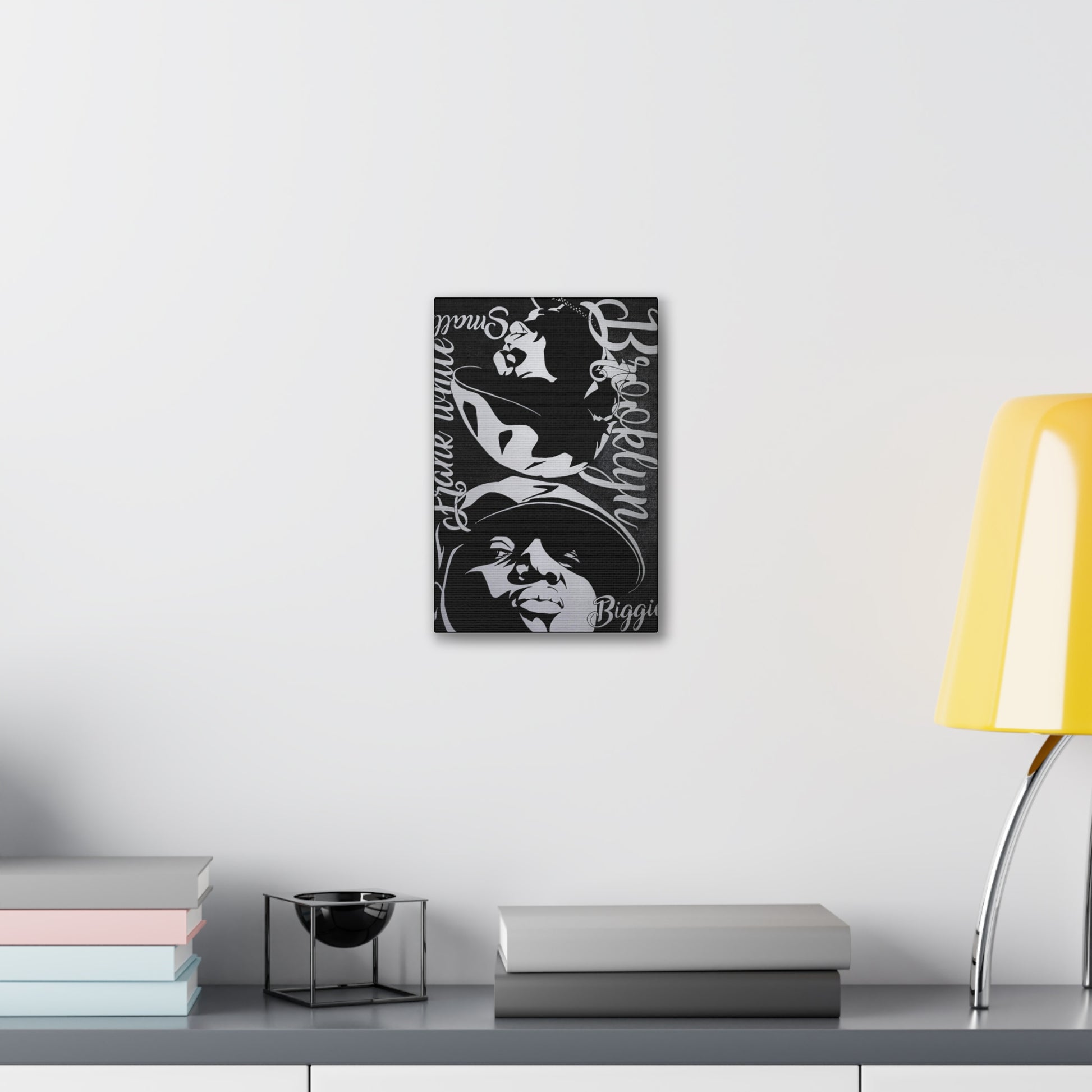A black and white canvas gallery wrap featuring two stylized portraits of Biggie Smalls.