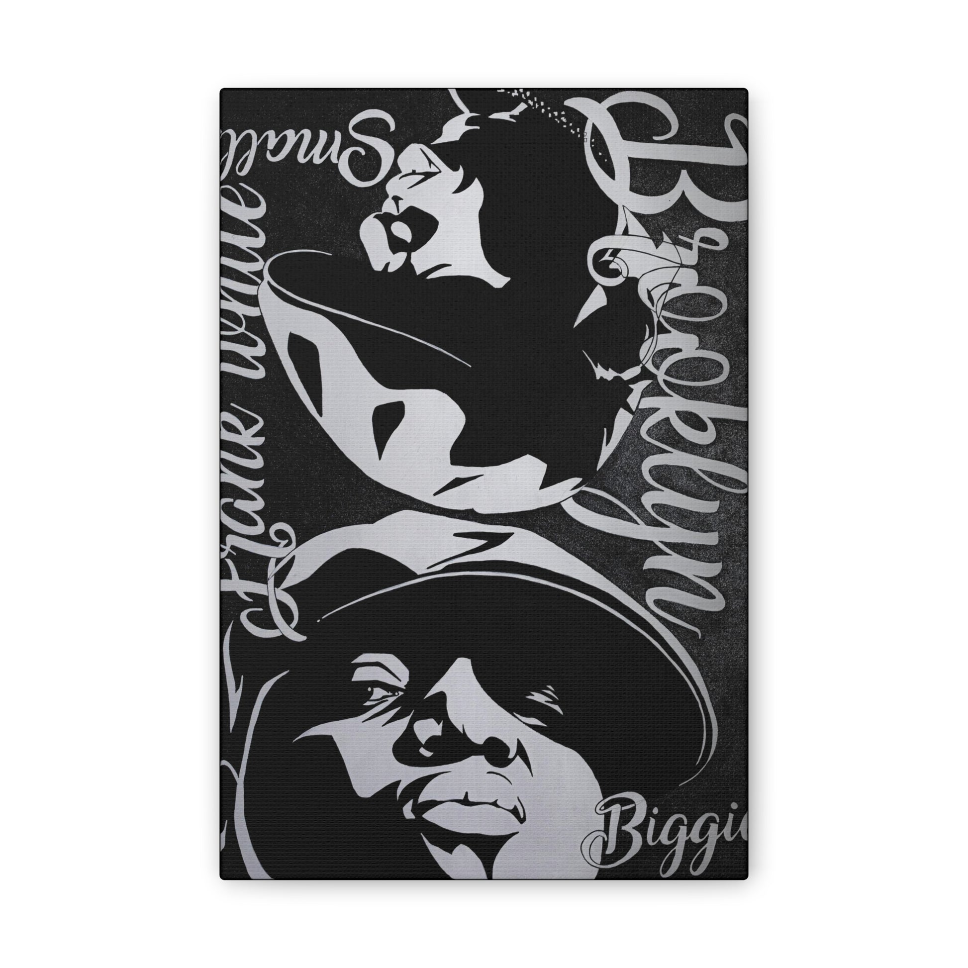 A black and white canvas print features portraits of Amy Winehouse and Biggie Smalls.